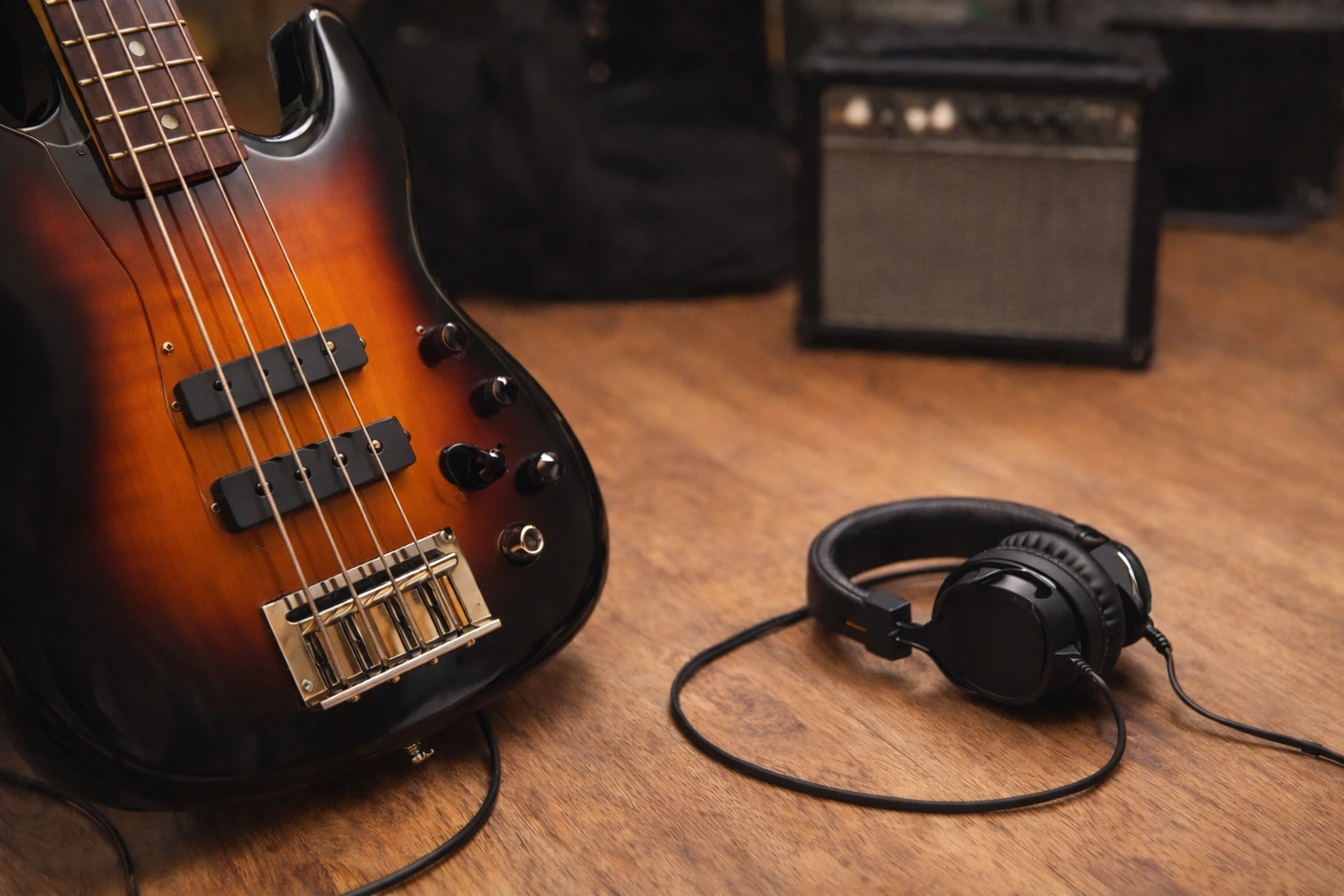 Sunburst bass guitar and headphones for a beginner bass setup